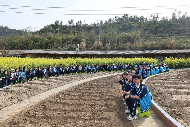 同學們在田間地頭合影留念。校方供圖