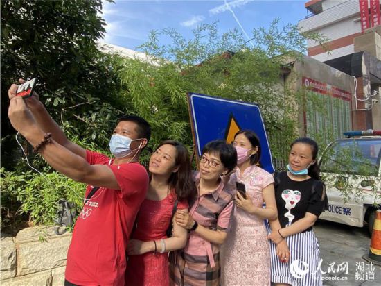 湖北省水果湖高级中学考点,家长为学生送考。人民网 肖璐欣摄